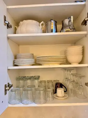 a pantry filled with jars and plates and dishes at Pearl Garden Studio Luxueux Piscine Sunny Terrasse in Marrakech