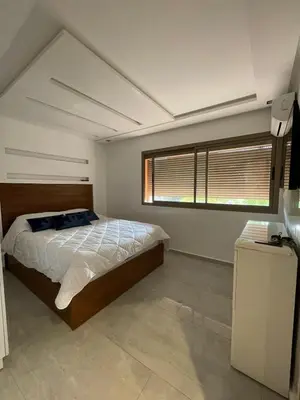 a bedroom with a large bed and a window at Bel Appartement Hivernage-Gueliz 2 chambres in Marrakech