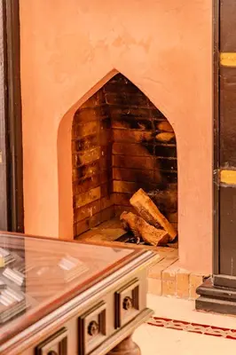 a brick oven with a fireplace in a room at Luxury Villa with Pool, Garden & Gated Security in Marrakech