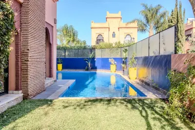 a swimming pool in the backyard of a house at Luxury Villa with Pool, Garden & Gated Security in Marrakech