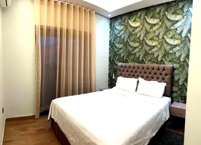 a bedroom with a bed with a floral wall at Appartement luxueux, cosy & confortable in Marrakech