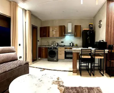 a kitchen with a table and a stove top oven at Appartement luxueux, cosy & confortable in Marrakech