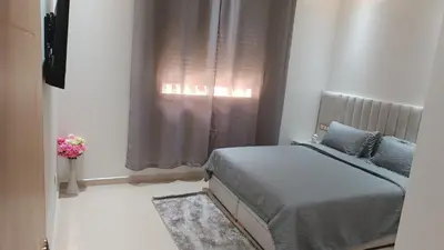a bedroom with a bed in front of a window at Chez bousfyha 2 in Marrakech