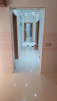 an empty hallway in a building with doors open at Chez bousfyha 2 in Marrakech