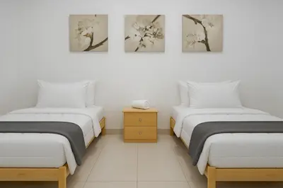 two beds in a room with white walls at Atlas Royale Marrakech in Marrakech