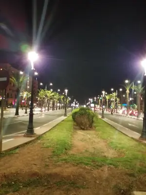 a city street at night with street lights at Magnifique appartement in Marrakech