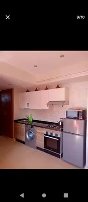 a kitchen with a stove and a dishwasher at Magnifique appartement in Marrakech