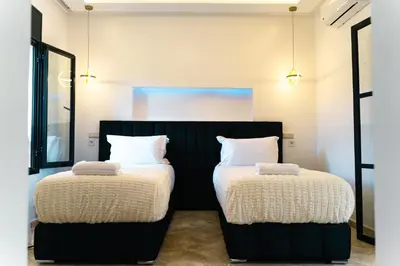 two beds sitting next to each other in a room at Villa oasis private pool secure complex in Marrakech