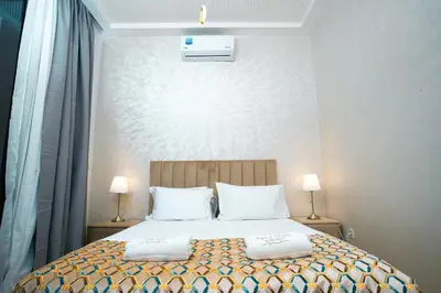 a bedroom with a large bed with two pillows at Villa oasis private pool secure complex in Marrakech
