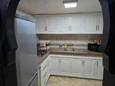 a kitchen with white cabinets and a sink at Riad Miralezia in Marrakech