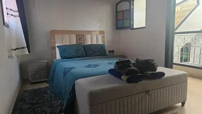 a bedroom with a bed with towels on top of it at Riad Miralezia in Marrakech