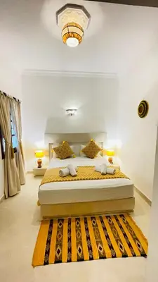 a bedroom with a large bed in a room at Riad dei colori in Marrakech