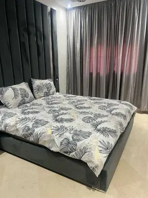 a bed with a black headboard and pillows on it at Riad Arfoud appartement haut standing 3 chambres avec piscine à gueliz nord in Marrakech