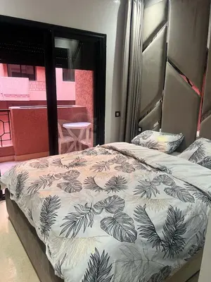 a bedroom with a bed with a black and white comforter at Riad Arfoud appartement haut standing 3 chambres avec piscine à gueliz nord in Marrakech