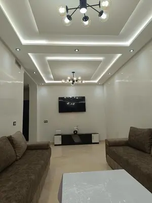 a living room with two couches and a flat screen tv at Riad Arfoud appartement haut standing 3 chambres avec piscine à gueliz nord in Marrakech