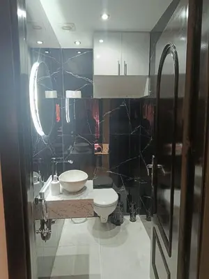 a bathroom with a white toilet and a sink at Riad Arfoud appartement haut standing 3 chambres avec piscine à gueliz nord in Marrakech