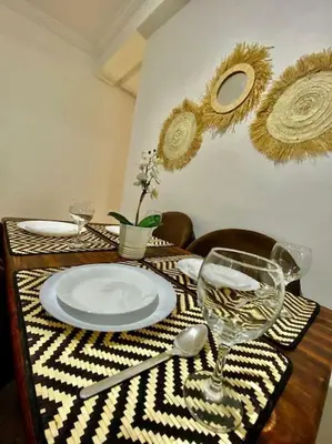 a table with a plate and a glass of wine at apparte 2 chambres de luxe en face la gare gueliz in Marrakech