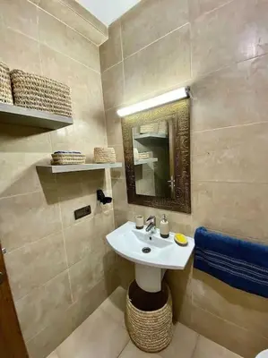 a bathroom with a sink and a mirror at apparte 2 chambres de luxe en face la gare gueliz in Marrakech