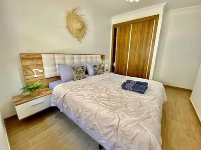 a bedroom with a large bed with blue pillows at apparte 2 chambres de luxe en face la gare gueliz in Marrakech