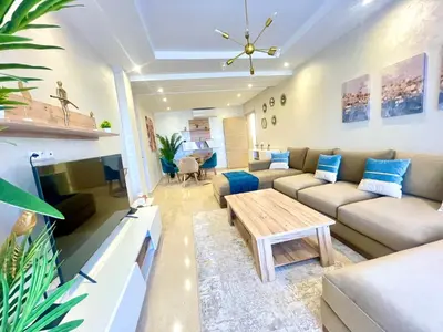 a living room with a couch and a table at Les Douces Nuits De Marrakech in Marrakech