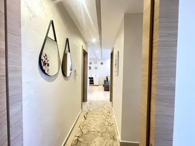 a hallway with three surfboards on the wall at Les Douces Nuits De Marrakech in Marrakech