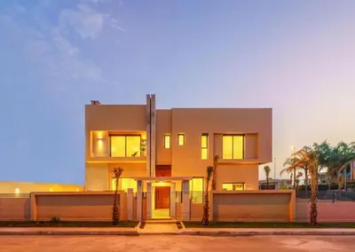 a large white building with palm trees in front of it at Sublime Villa A in Marrakech