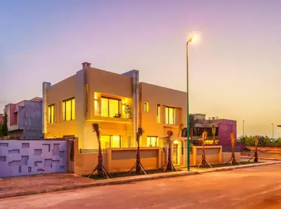 a yellow building on a street with a street light at Sublime Villa A in Marrakech