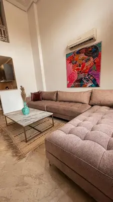 a living room with a couch and a table at Duplex Jasmine in Marrakech