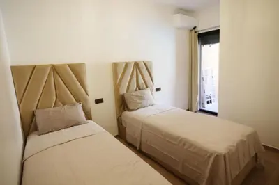 a bedroom with two beds and a window at Appartement de lux in Marrakech
