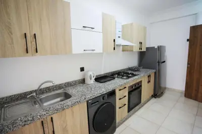 a kitchen with a sink and a stove at Appartement de lux in Marrakech