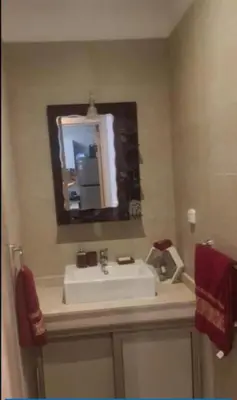 a bathroom with a sink and a mirror at Charming Apartment in the Heart of Marrakech - Modern Amenities and Prime Location in Marrakech