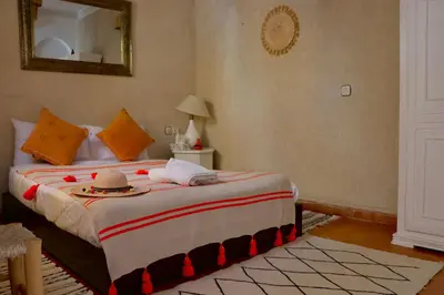 a bedroom with a bed with a hat on it at Riad CHEZ MOI in Marrakech