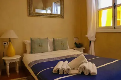 a bedroom with a bed with towels on it at Riad CHEZ MOI in Marrakech