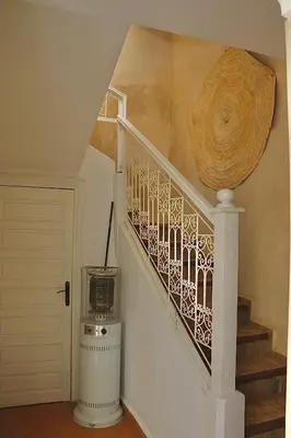 a stairwell with a spiral staircase with a fan at Riad CHEZ MOI in Marrakech