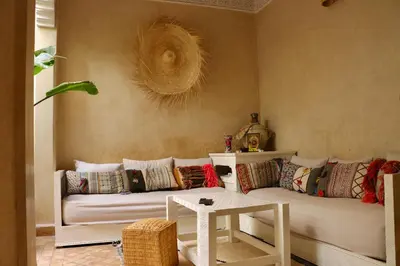 a living room with a white couch and a table at Riad CHEZ MOI in Marrakech