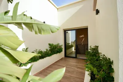 an open door of a building with plants at Somptueuse Family Villa Cherifa avec piscine chauffée in Marrakech