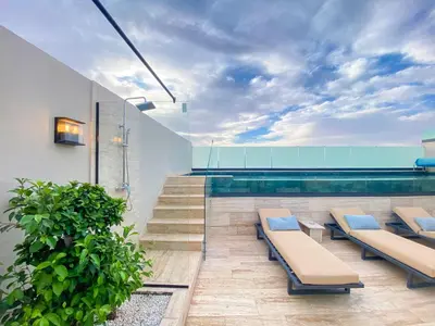 a swimming pool with benches next to a swimming pool at Triplex de luxe Santorini piscine privée chauffée 3 chambres in Marrakech