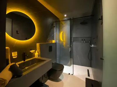 a bathroom with a sink and a shower at Triplex de luxe Santorini piscine privée chauffée 3 chambres in Marrakech