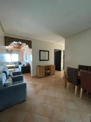 a living room with couches and a dining room at L'empreinte Appart Marrakech in Marrakech