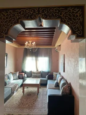 a living room with a couch and a table at L'empreinte Appart Marrakech in Marrakech