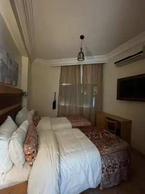 a bedroom with a large white bed and a window at L'empreinte Appart Marrakech in Marrakech