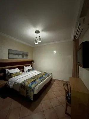 a bedroom with a large bed in a room at L'empreinte Appart Marrakech in Marrakech