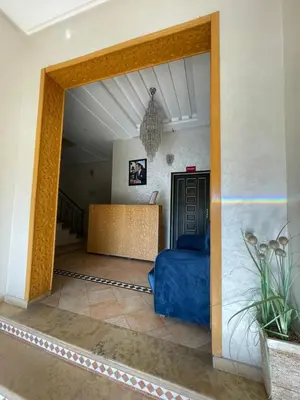 a living room with a blue couch in a room at L'empreinte Appart Marrakech in Marrakech