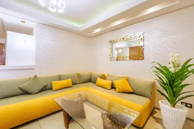 a living room with a yellow couch and a mirror at Menara garden in Marrakech