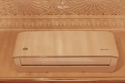a white refrigerator freezer sitting on top of a wall at Riad Aslal in Marrakech