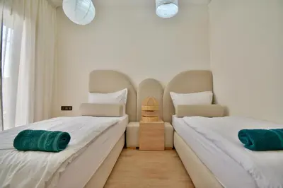 two beds sitting next to each other in a bedroom at Superbe appart cosy avec piscine in Marrakech