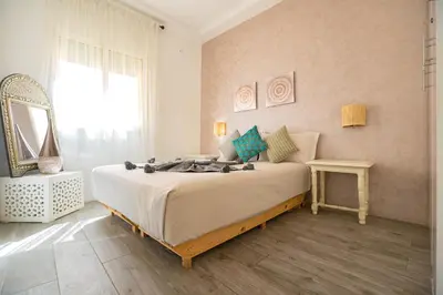a bedroom with a large bed with a mirror at Appartamento 14 a Guelize Hivernage in Marrakech
