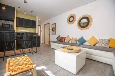 a living room with a couch and a table at Appartamento 14 a Guelize Hivernage in Marrakech