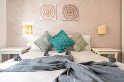 a bedroom with a bed with a blanket on it at Appartamento 14 a Guelize Hivernage in Marrakech