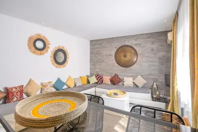a living room with a table and a couch at Appartamento 14 a Guelize Hivernage in Marrakech